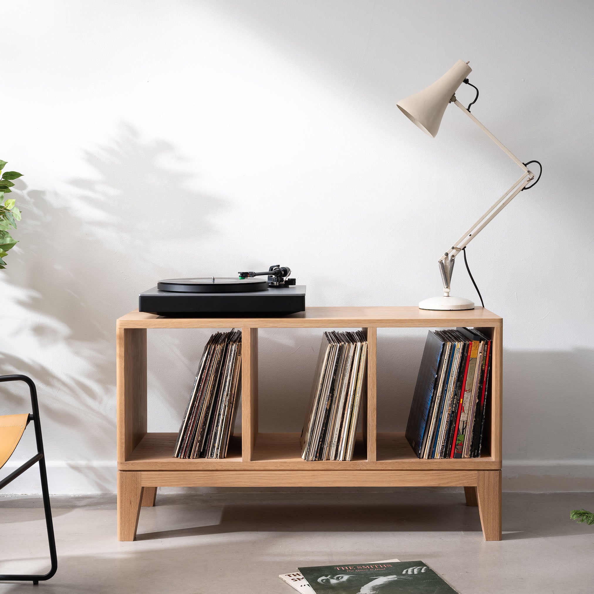 Vinyl record storage cabinet setup with turntable on top