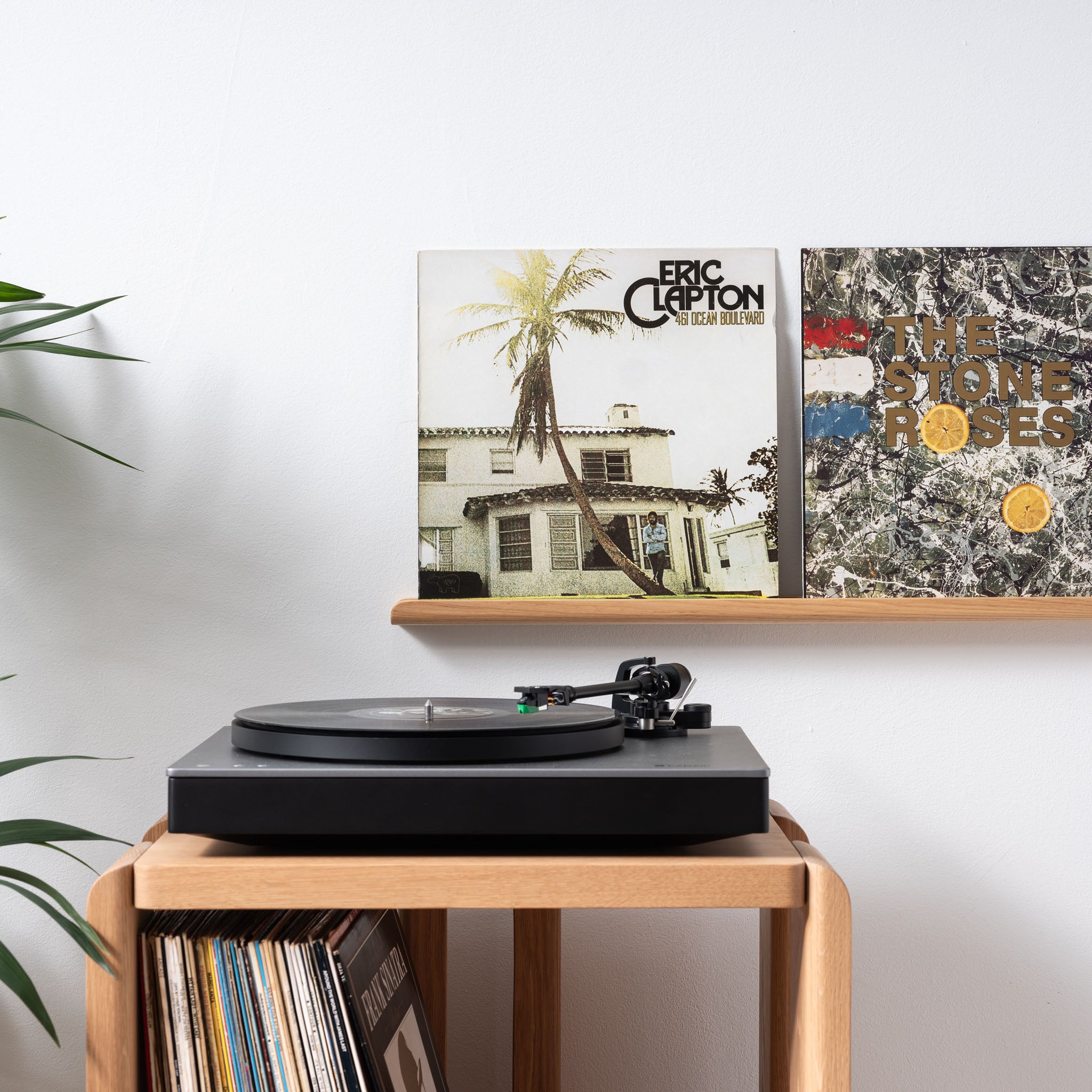 vinyl record shelf with turntable on cabinet
